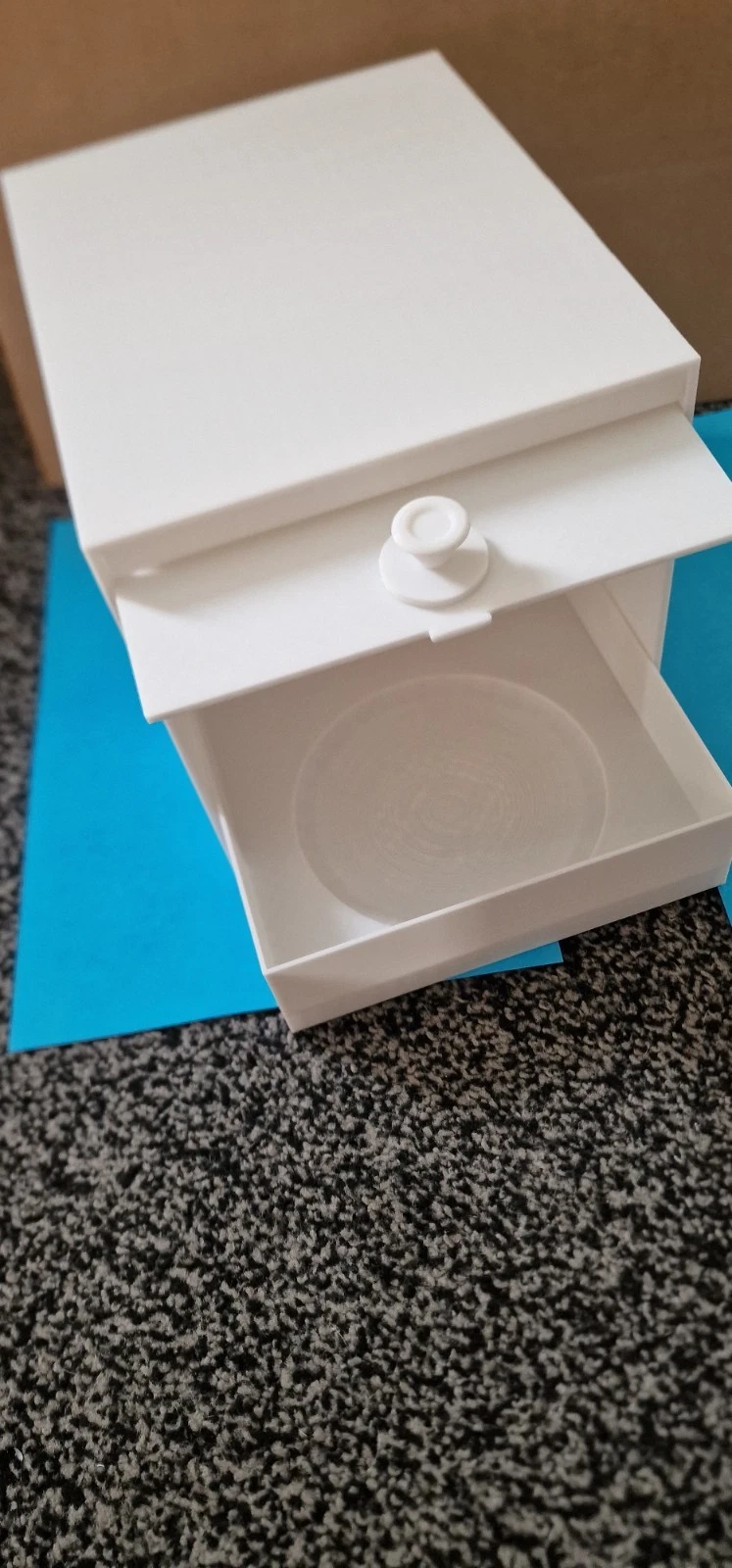 BirdCraft plastic nest box with its drawer open, showing the concave